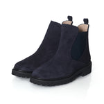 Pair of dark blue suede Chelsea boots on a white background