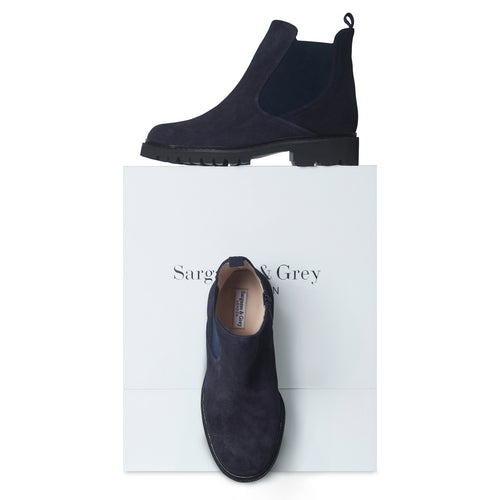 Navy blue Chelsea boots on a white box with 'Sarge & Grey' branding.